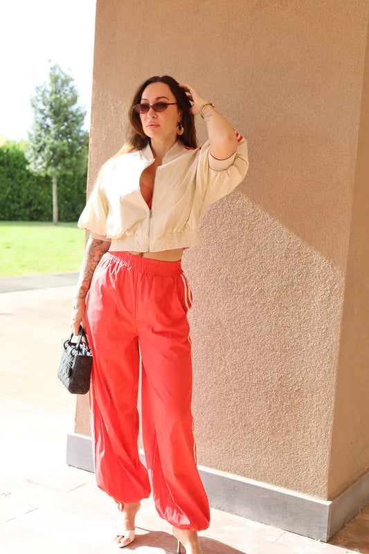Lumina Milan Luxury Athleisure Set - front view of cream cropped bomber jacket and coral red joggers on a model